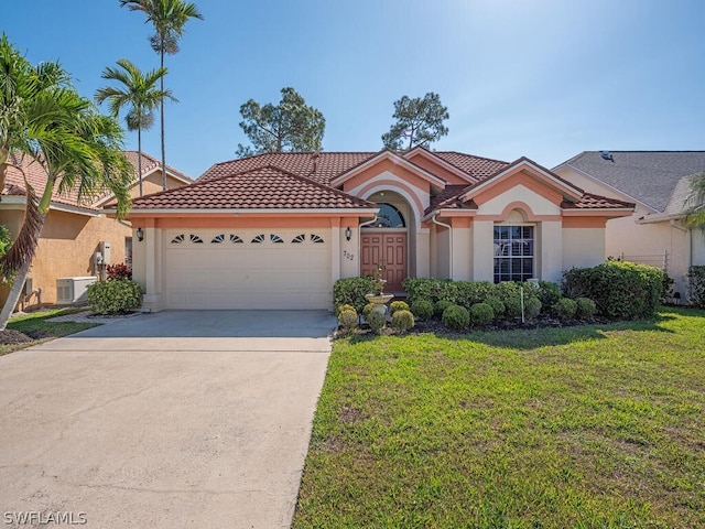 mediterranean / spanish-style home featuring a front lawn and a garage