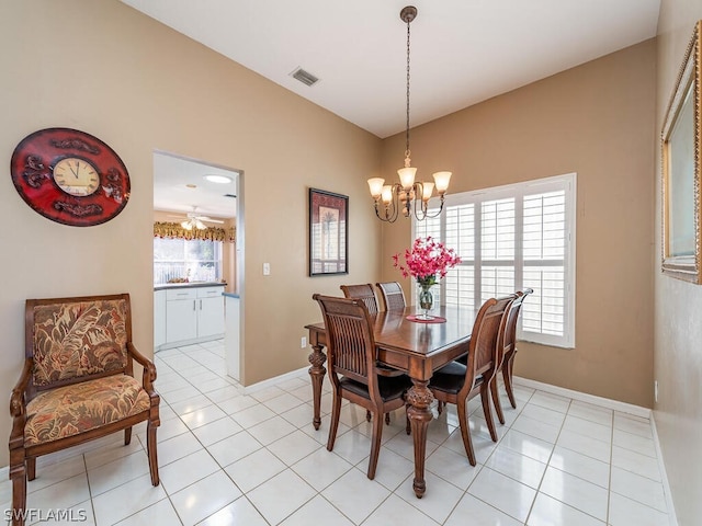 dining room featuring light tile floors and ceiling fan with notable chandelier