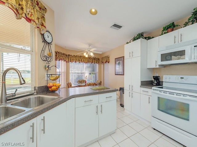 kitchen featuring white cabinetry, white appliances, light tile flooring, and ceiling fan