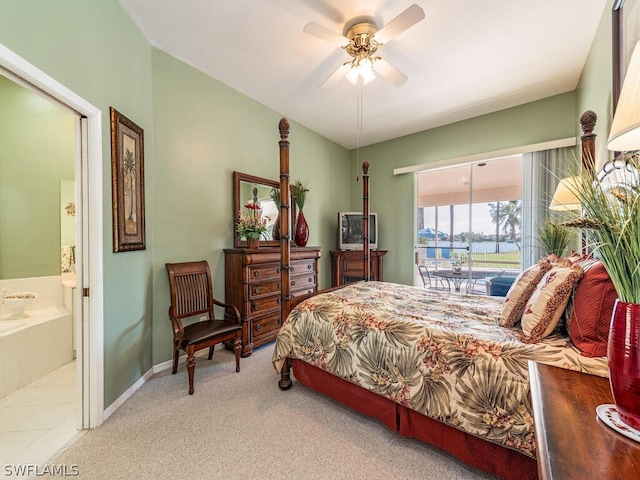 bedroom with ceiling fan, connected bathroom, light carpet, and access to exterior