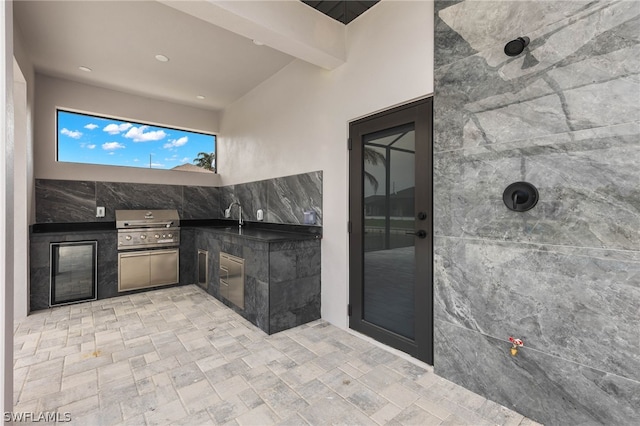 view of patio with sink, exterior kitchen, and grilling area