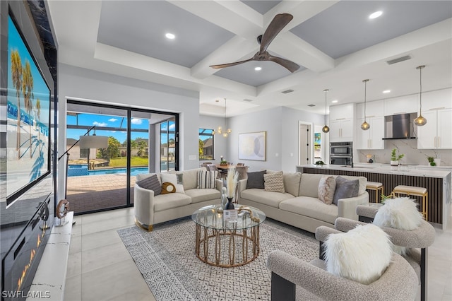 living room featuring beamed ceiling, coffered ceiling, light tile floors, and ceiling fan with notable chandelier