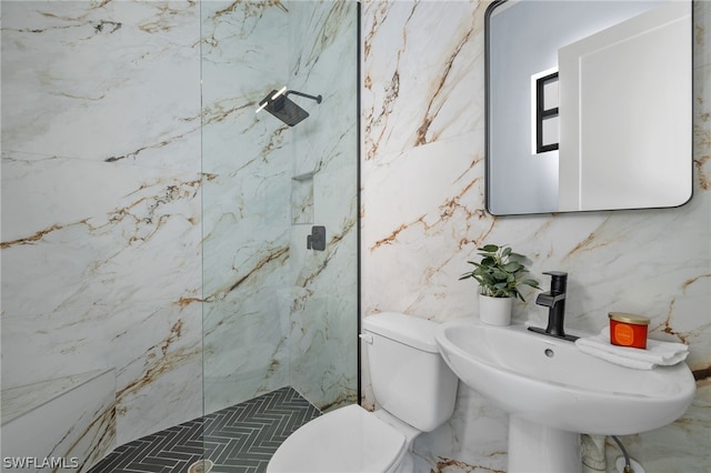 bathroom with tile walls, sink, a shower, and toilet