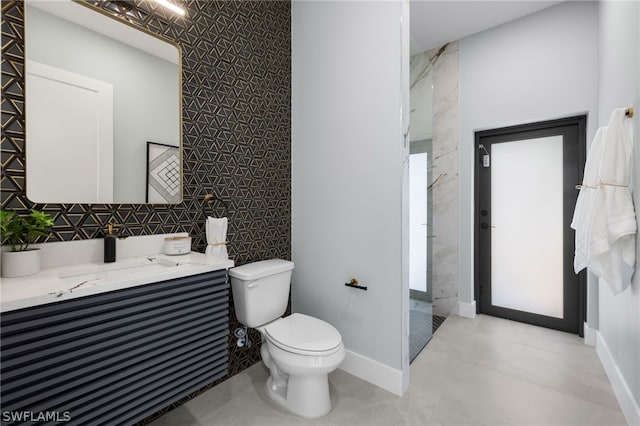 bathroom with tiled shower, tile floors, tile walls, vanity, and toilet