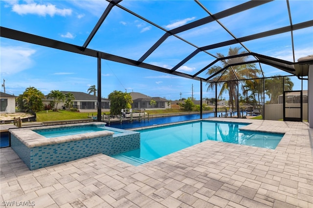 view of swimming pool with a patio area, glass enclosure, and an in ground hot tub