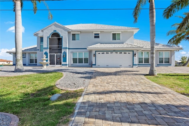 view of front facade with a front yard and a garage