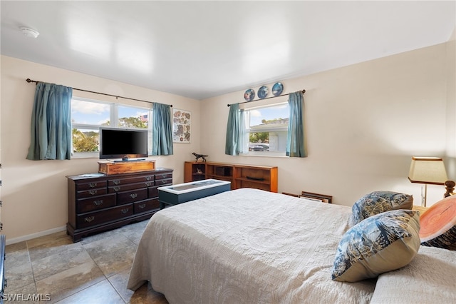 tiled bedroom with multiple windows