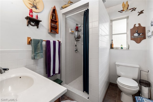 bathroom featuring tile walls, toilet, sink, tiled shower, and tile floors