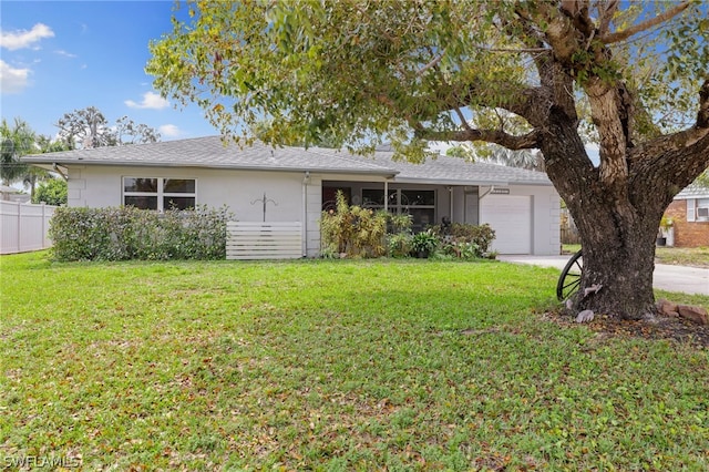 single story home featuring a front yard and a garage