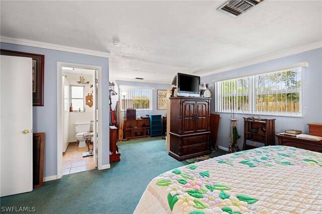 bedroom with ornamental molding, connected bathroom, and carpet flooring