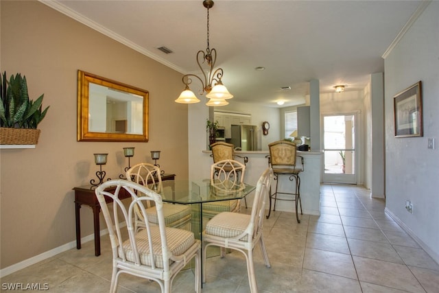 tiled dining area featuring crown molding