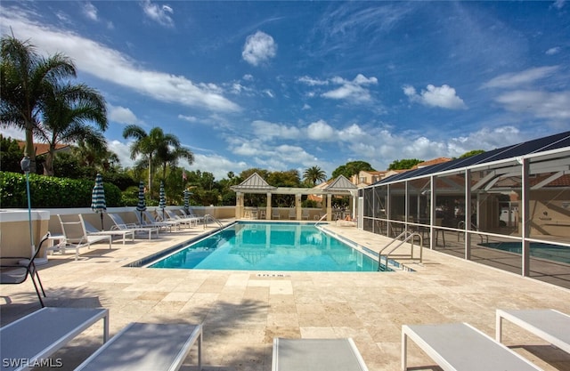 view of pool with a lanai and a patio area