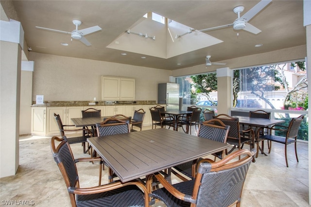 view of patio / terrace featuring ceiling fan, an outdoor bar, and area for grilling