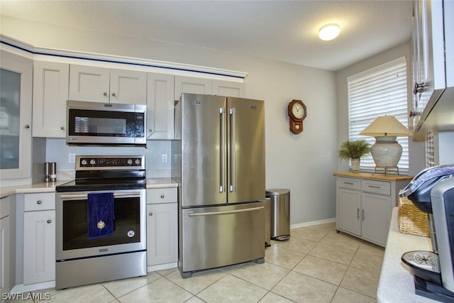 kitchen featuring appliances with stainless steel finishes and light tile patterned floors