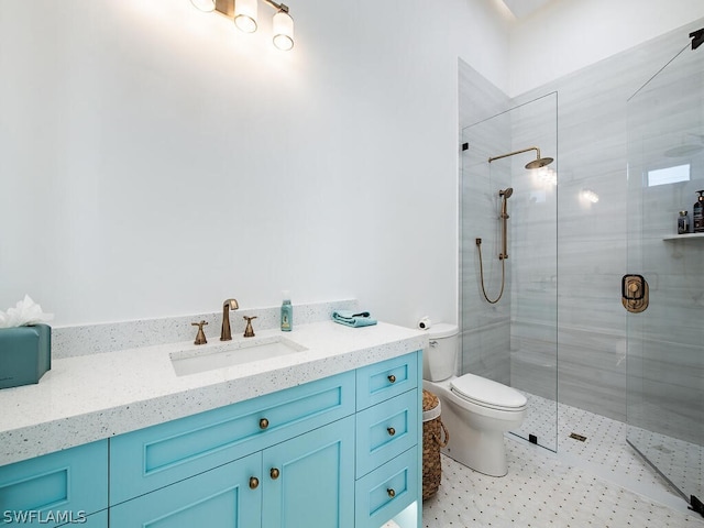 bathroom featuring vanity, tile floors, toilet, and tiled shower