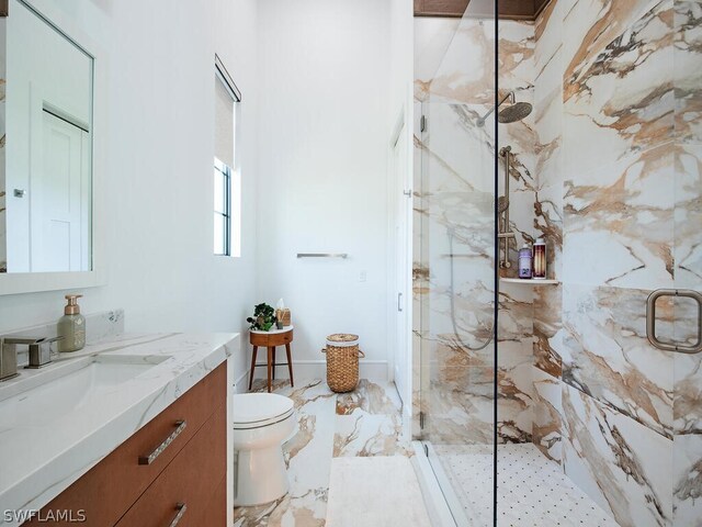 bathroom featuring vanity, a shower with door, tile flooring, and toilet