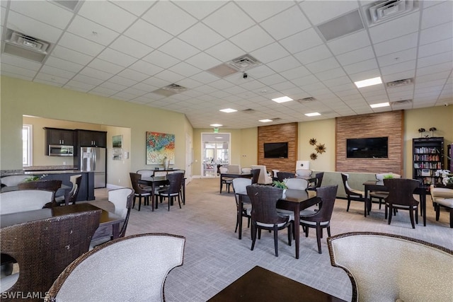 dining space featuring a drop ceiling