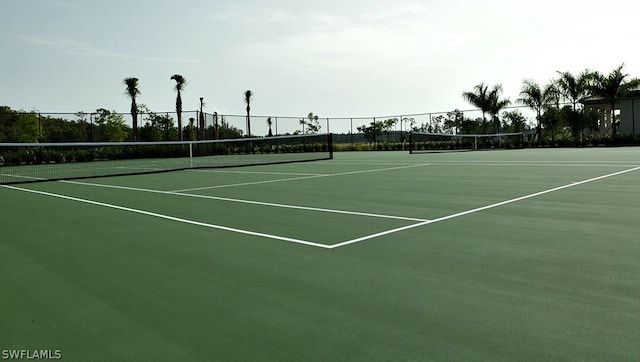 view of tennis court featuring basketball hoop