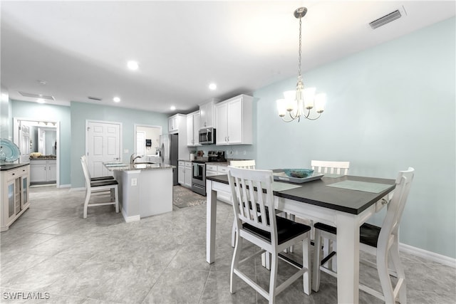 dining area featuring a notable chandelier and sink