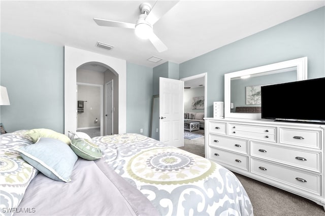 carpeted bedroom featuring ceiling fan and ensuite bathroom