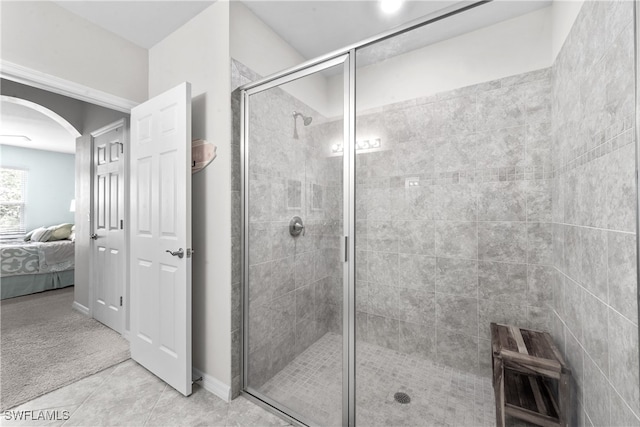 bathroom featuring tile patterned flooring and a shower with door