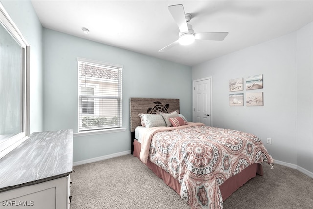 carpeted bedroom with ceiling fan and a closet