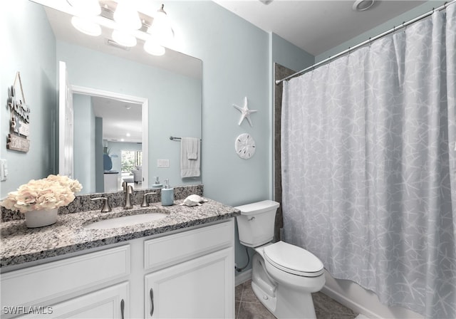 full bathroom with tile patterned flooring, shower / bath combination with curtain, vanity, and toilet