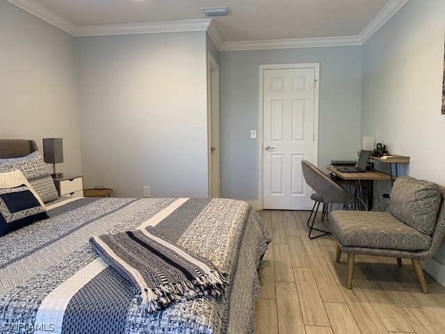 bedroom featuring light hardwood / wood-style floors and ornamental molding