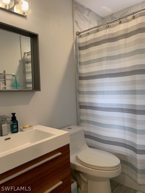 bathroom featuring toilet and vanity