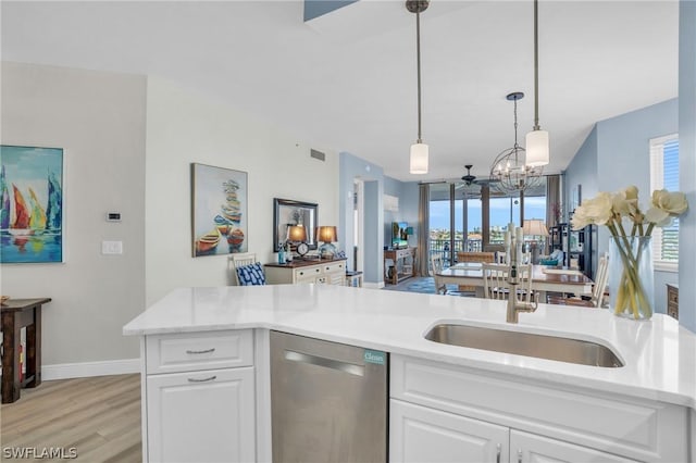 kitchen featuring white cabinetry, dishwasher, plenty of natural light, and pendant lighting