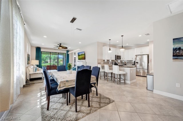 tiled dining space featuring ceiling fan