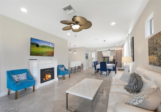 living room with light tile flooring and ceiling fan