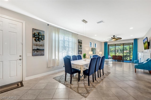 dining space featuring ceiling fan and light tile floors