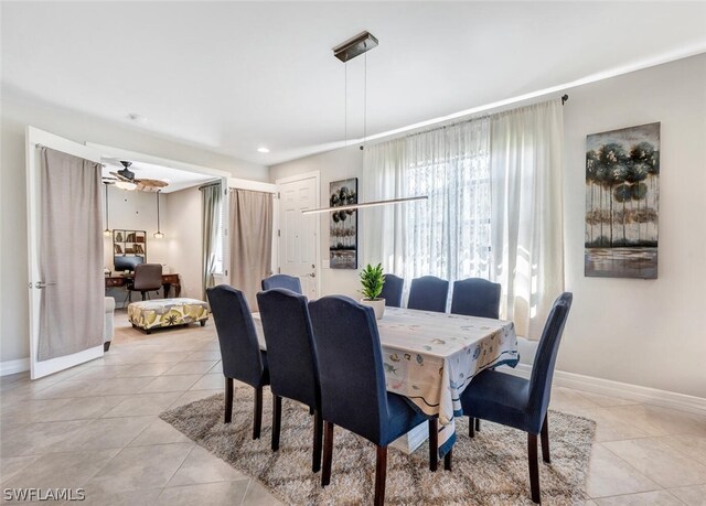 tiled dining area with ceiling fan