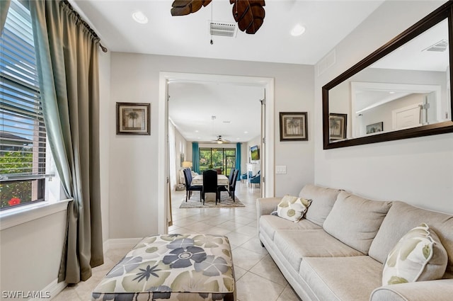 tiled living room featuring ceiling fan