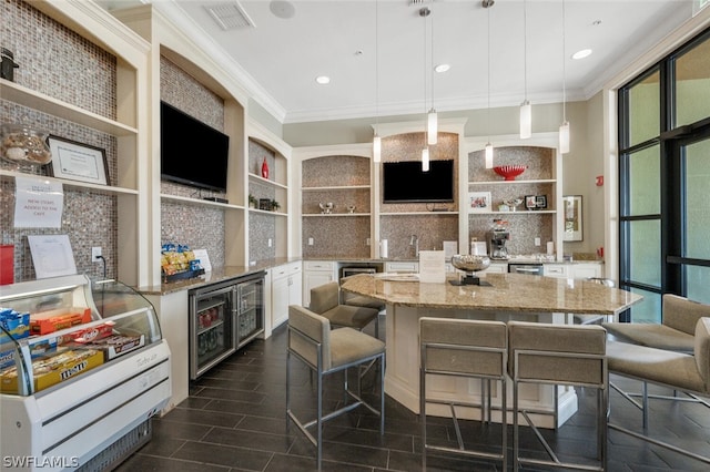 kitchen featuring pendant lighting, a kitchen breakfast bar, a kitchen island, and white cabinets