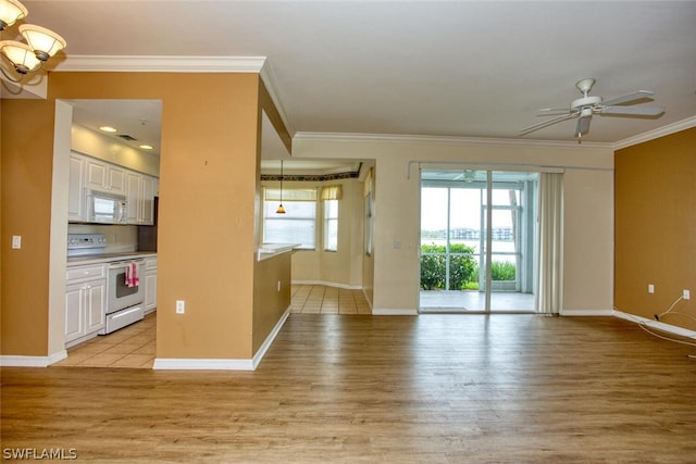 unfurnished living room with ceiling fan, light hardwood / wood-style flooring, and ornamental molding