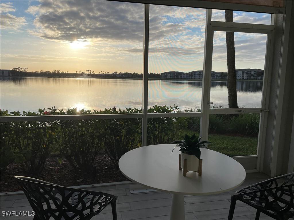 sunroom / solarium with a water view