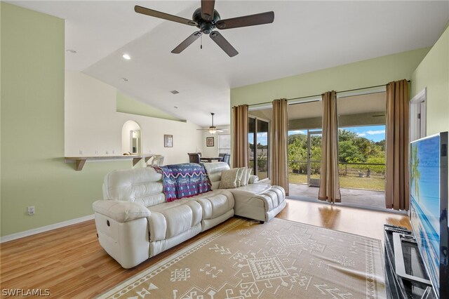 living room featuring high vaulted ceiling, light hardwood / wood-style floors, and ceiling fan