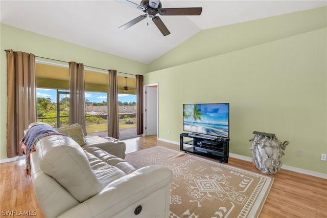 living room with ceiling fan, lofted ceiling, and light wood-type flooring