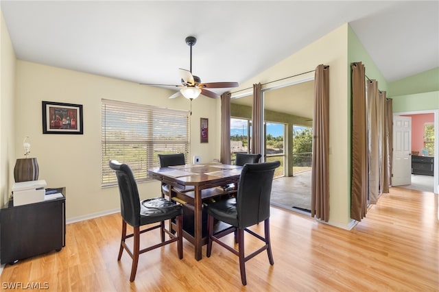 dining room featuring light wood-type flooring, ceiling fan, a healthy amount of sunlight, and vaulted ceiling