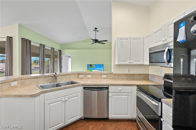 kitchen featuring white cabinets, appliances with stainless steel finishes, sink, ceiling fan, and vaulted ceiling