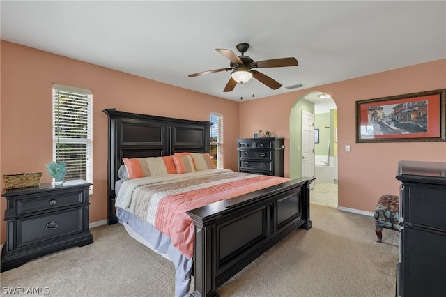 carpeted bedroom featuring ceiling fan and connected bathroom