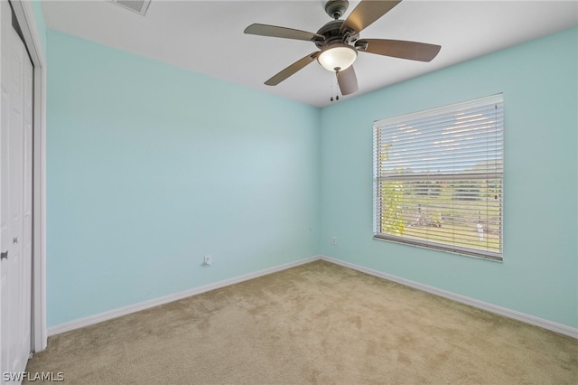 carpeted empty room with ceiling fan