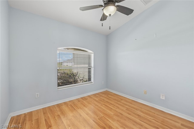 spare room featuring light hardwood / wood-style floors, ceiling fan, and lofted ceiling