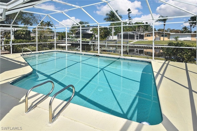 view of pool with glass enclosure