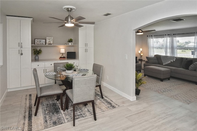 dining area with ceiling fan and light hardwood / wood-style flooring