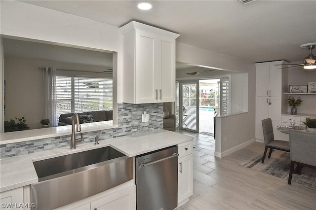 kitchen featuring white cabinets, dishwasher, backsplash, and ceiling fan