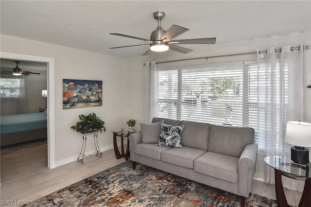 living room featuring ceiling fan and light wood-type flooring