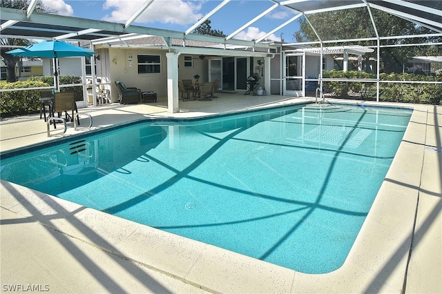 view of pool with a lanai and a patio